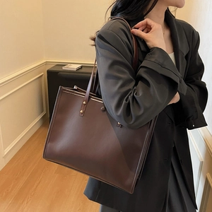 Classic dark brown leather tote bag for women with gold rivets and spacious design