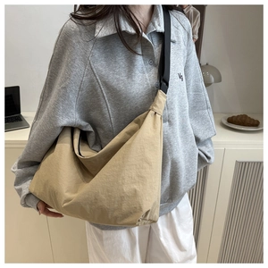 Détail d'un grand sac bandoulière kaki avec sangle réglable et texture en nylon