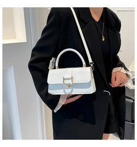 White leather small square bag with gold D-buckle shown on model for daily commute style