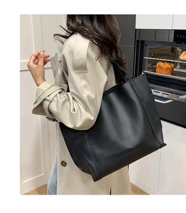 Side view of large black minimalist tote bag in matte PU leather for daily commuting