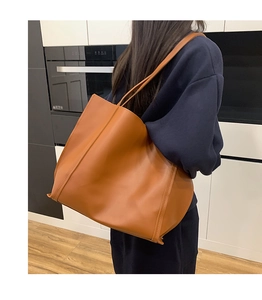 Caramel brown large capacity tote bag shown from behind with elegant shoulder strap