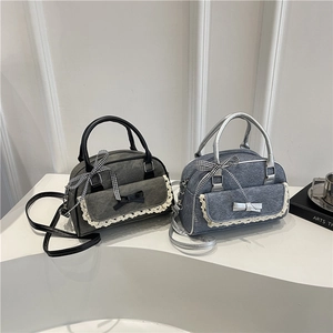 Chic denim and canvas boston bags with lace trim and ribbon bows in blue and grey