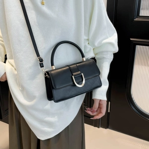 Chic black crossbody bag with silver U-shaped metal buckle and top handle for women