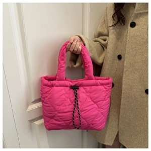 Detail of hot pink quilted tote bag with heart embroidery and adjustable drawstring closure