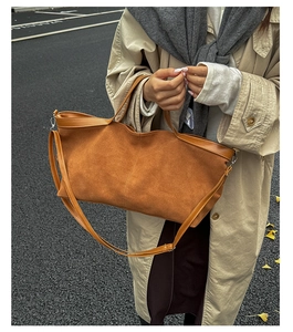 Brown matte suede tote bag styled with a beige trench coat for an autumn commute look