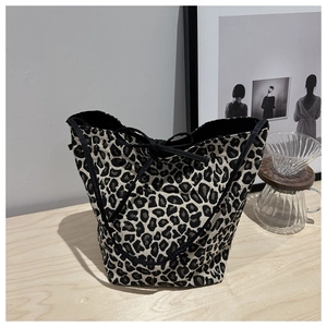 Detail of leopard print canvas tote bag featuring black drawstring and inner lining texture