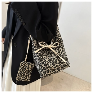 Detail of leopard print canvas tote bag with cream bow and matching small coin purse