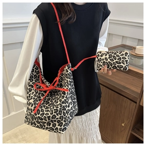 Detail of leopard print bucket bag set with red straps and matching inner pouch