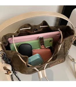 Detail view of large interior capacity of leopard bucket bag with tablet and phone