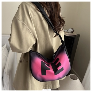 Detail of crescent moon bag with pink and black gradient finish and FE lettering