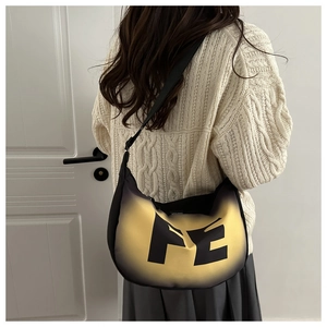 Detail of trendy black and yellow gradient shoulder bag with large FE letter design