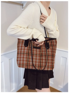 Detail showing plush plaid tote bag with red and blue checkers and sturdy black straps