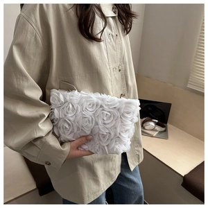 Close-up of white 3D fabric rose texture on a stylish evening clutch bag for women