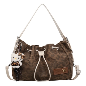Fashionable leopard print canvas bucket bag with drawstring closure and crossbody strap