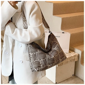 Detailed view of large woven tote bag featuring retro geometric pattern and wide strap