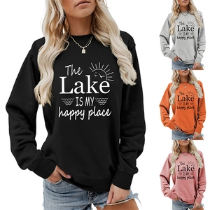 Close-up of crewneck sweatshirts in black, grey, orange and pink with graphic print