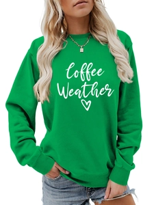 Detail of green Coffee Weather sweatshirt featuring white cursive text and heart graphic