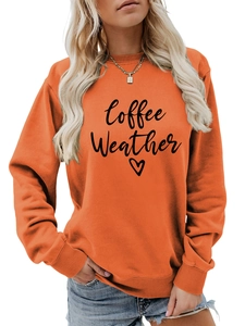 Close-up of Coffee Weather typography and heart print on orange cotton sweatshirt