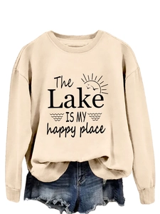 Detail view of The Lake Is My Happy Place print on a beige crewneck sweatshirt