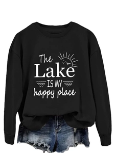 Detail of screen-printed text and nature icons on a black long sleeve crewneck sweatshirt