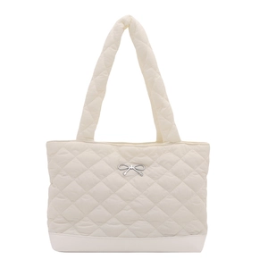 Quilted tote bag with diamond stitching and silver bow detail in creamy white