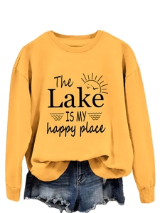 Close-up of yellow sweatshirt with The Lake Is My Happy Place print and sun graphics