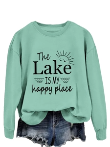 Detail of mint green sweatshirt featuring The Lake Is My Happy Place graphic text
