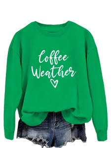 Detail of bright green Coffee Weather sweatshirt featuring white cursive print and heart design