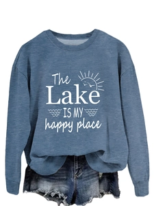 Detail of blue crewneck sweatshirt with The Lake Is My Happy Place graphic and denim shorts