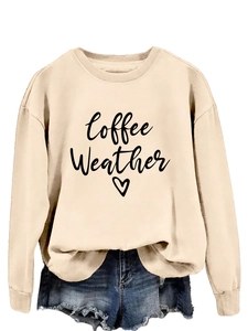 Detail of coffee weather script and heart print on beige crewneck sweatshirt fabric