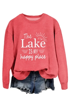 Detail of watermelon red sweatshirt with The Lake Is My Happy Place print and raw denim shorts