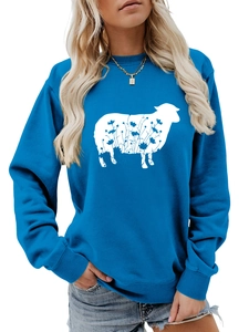 Detail of bright blue crewneck sweatshirt featuring artistic white sheep floral print