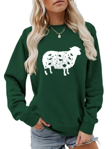 Detail of green crewneck sweatshirt featuring a floral sheep silhouette graphic print