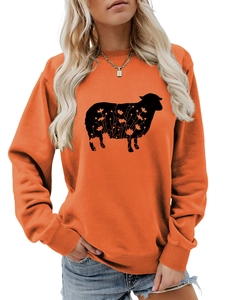 Detail of orange crewneck sweatshirt featuring a black sheep silhouette with floral patterns