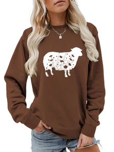 Detail of a brown sweatshirt featuring a white sheep silhouette with floral patterns