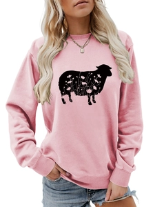 Detailed view of pink crewneck sweatshirt featuring a black floral sheep print design