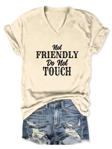 Close-up of V-neck tee with Not Friendly text print and distressed denim shorts