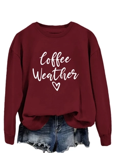 Detail of burgundy sweatshirt with white Coffee Weather heart print and crew neck design