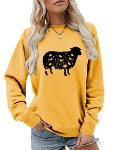 Detail of mustard yellow sweatshirt featuring a black goat and floral silhouette print