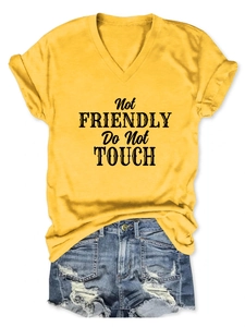 Detail of yellow V-neck T-shirt with black Not Friendly Do Not Touch slogan print