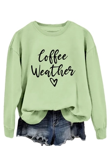 Detail of light green sweatshirt with Coffee Weather print and casual denim shorts