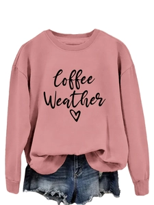 Flat lay of pink sweatshirt with Coffee Weather print paired with denim shorts