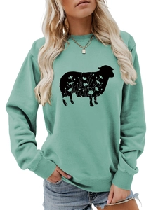 Close-up of mint green sweatshirt featuring floral sheep print and ribbed cuffs