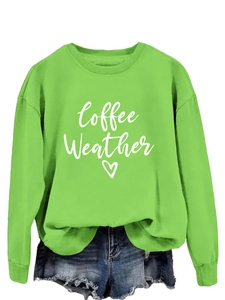 Detail of lime green sweatshirt with white Coffee Weather print and heart pattern
