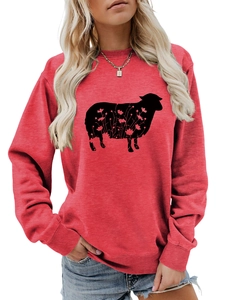 Detail of red crewneck sweatshirt featuring a black goat silhouette with floral patterns