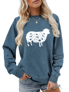Detail of navy blue sweatshirt showing white sheep silhouette with black floral patterns