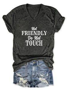 Detail of V-neck tee with Not Friendly text paired with distressed denim shorts
