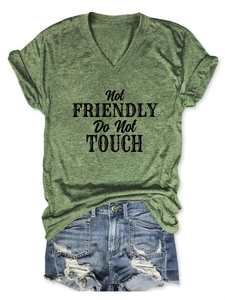 Flat lay of a green V-neck T-shirt with black Not Friendly Do Not Touch text detail