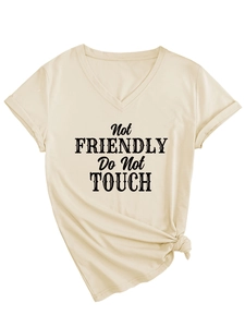 Detail of side knot hem on beige V-neck T-shirt with black Not Friendly slogan text