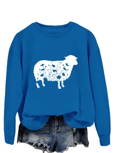Detail of floral sheep print on blue crewneck sweatshirt with raw hem denim shorts